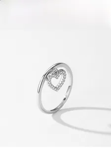 Close-up of 925 sterling silver ring with a dangling heart pendant and cubic zirconia