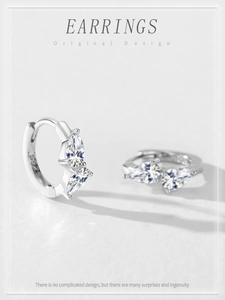 Macro shot of S925 sterling silver hoop earrings with marquise-cut clear stones