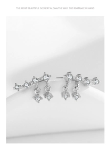 Macro shot of S925 silver fringe earrings with sparkling round and square cubic zirconia