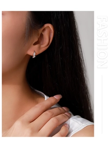 Close-up of 925 sterling silver drop earrings with marquise-cut zircons in leaf design