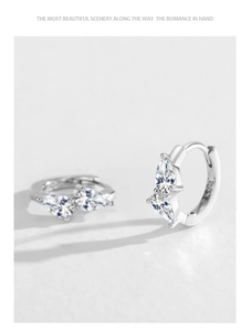 Detail view of 925 sterling silver hoop earrings with teardrop cubic zirconia settings