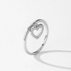 Elegant 925 sterling silver ring with a dangling hollow heart charm and cubic zirconia stones