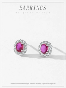 Detail of silver stud earrings with oval pink main stone and white cubic zirconia halo
