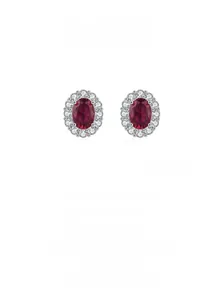 Macro shot of 925 sterling silver halo stud earrings with luxury red cubic zirconia stones