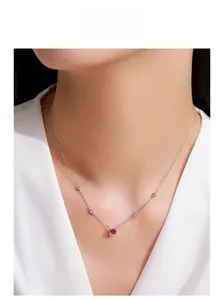 Close-up of 925 sterling silver necklace with red square gemstone on female model