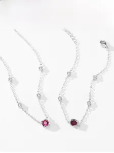 Detail of square red corundum pendant on 925 sterling silver chain with zircon accents