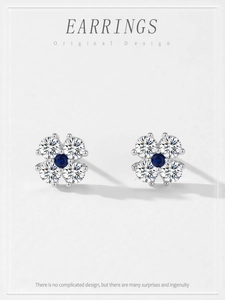 Macro detail of 925 silver four-leaf clover stud earrings with blue and clear cubic zirconia