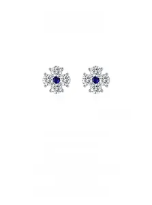 Macro detail of 925 sterling silver four-leaf clover earrings with blue sapphire zircon