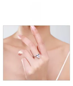 Detail of a pear-cut 3-carat solitaire engagement ring in s925 silver on a model hand