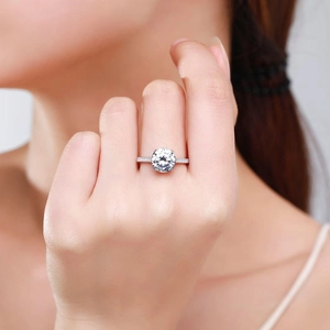 Elegant S925 sterling silver four-prong 2ct moissanite ring worn on a model's finger