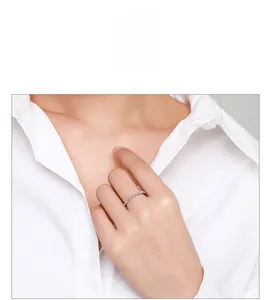 Close-up of S925 sterling silver baguette cut diamond ring on a woman's finger