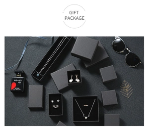 Macro view of matte black gift boxes with velvet inserts for necklaces and rings