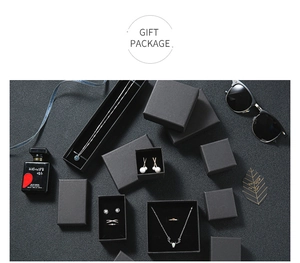 Luxury black matte jewelry gift boxes with various sizes on a textured stone background