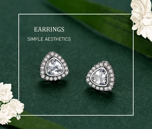 Detail of silver S925 triangle stud earrings with halo cubic zirconia in macro view