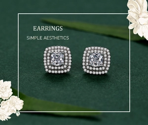 Close-up of square cushion-cut silver earrings with double halo of micro-pave crystals