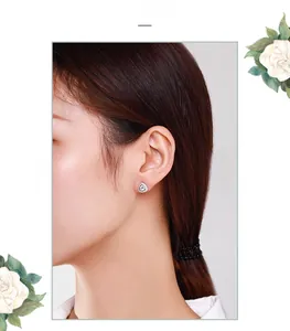 Detail of s925 silver triangle stud earrings with sparkling zircon on a female model