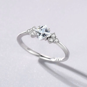Polished S925 silver ring featuring a princess cut zircon centerpiece and side stones