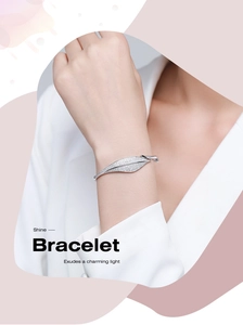 Detail of s925 silver leaf bracelet with shimmering pavé diamonds on a woman's wrist