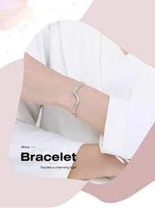 Detail of s925 silver wavy bracelet with micro-pave zirconia on a model wrist