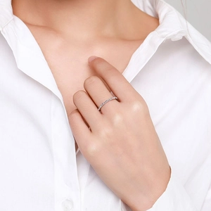 S925 sterling silver ring with baguette-cut zircons worn on hand against a white shirt