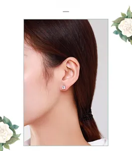 Detail view of S925 sterling silver square stud earrings with pave-set cubic zirconia on ear