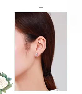 Close-up of elegant S925 silver square stud earrings with sparkling pavé cubic zirconia