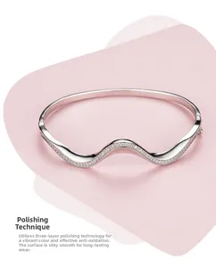 Detailed macro view of S925 sterling silver wave bangle with micro-paved cubic zirconia