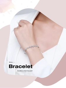 Detail of s925 silver wave bracelet with pavé zircons worn on model's wrist