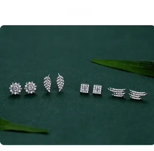 Detail of S925 silver feather and leaf earrings with sparkling cubic zirconia stones
