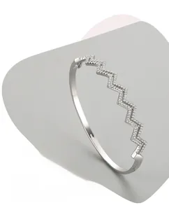 Detailed shot of S925 silver wave bangle featuring micro-set zircon and triple polishing