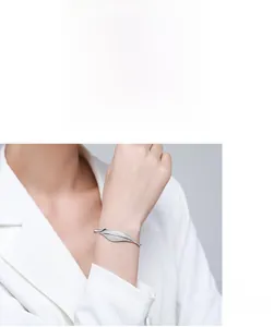 Detailed view of s925 sterling silver leaf bangle with white zircon pave setting