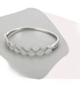 Detailed view of s925 silver wavy bangle with micro-pave white cubic zirconia stones