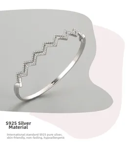 Detail of wavy S925 sterling silver cuff bracelet with micro-set white zircon stones