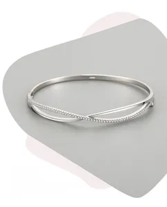 Macro detail of S925 sterling silver cross bangle with pavé-set cubic zirconia stones