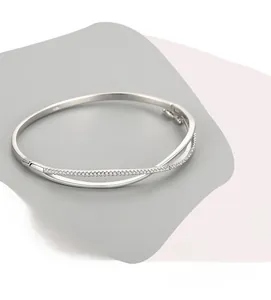 Detailed view of criss-cross sterling silver bangle with pavé-set cubic zirconia stones