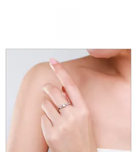 Close-up of a minimalist 925 sterling silver ring with micro-pave stars on a model's finger