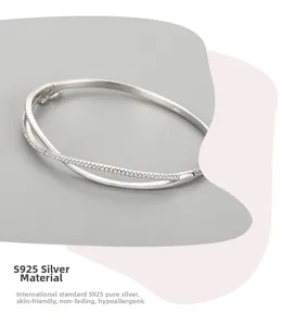 Close-up of S925 sterling silver bangle with crisscross design and sparkling white zircons