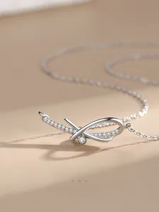 Macro shot of 925 sterling silver bow necklace with micro-pave cubic zirconia details
