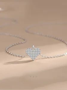 Macro shot of 925 silver pixel heart necklace with sparkling pavé zircons