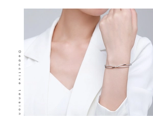 Close-up of S925 sterling silver open bracelet with crisscross zircon inlay on wrist