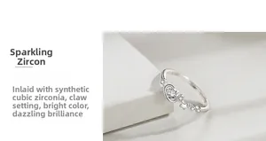 Detail of 925 sterling silver ring featuring star and planet motifs with prong-set cubic zirconia
