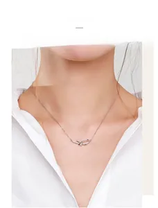 Close-up of 925 sterling silver bowknot necklace with micro-pave zircons on model