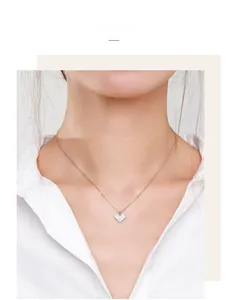 On-model view of a 925 sterling silver heart necklace with pavé-set sparkling stones
