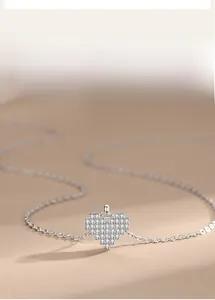Macro shot of 925 sterling silver heart pendant necklace with shimmering pave zircons