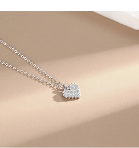 Macro view of pixel-style heart pendant with pavé cubic zirconia on S925 silver O-chain