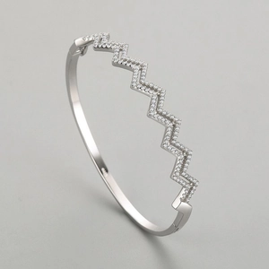Elegant wavy S925 sterling silver open bangle featuring sparkling cubic zirconia pave