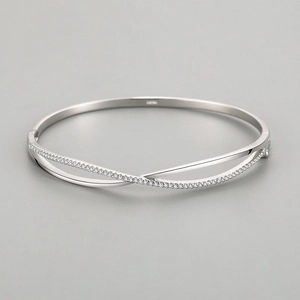 S925 sterling silver crisscross bangle with cubic zirconia accents on a clean background