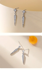 Macro detail of S925 silver arrow drop earrings with white zircon pavé setting