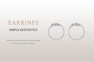 Close-up of S925 silver hoop earrings with three inlaid sparkling zircon gemstones