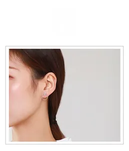 Close-up of minimalist s925 silver hoop earring with micro-set geometric stud on model